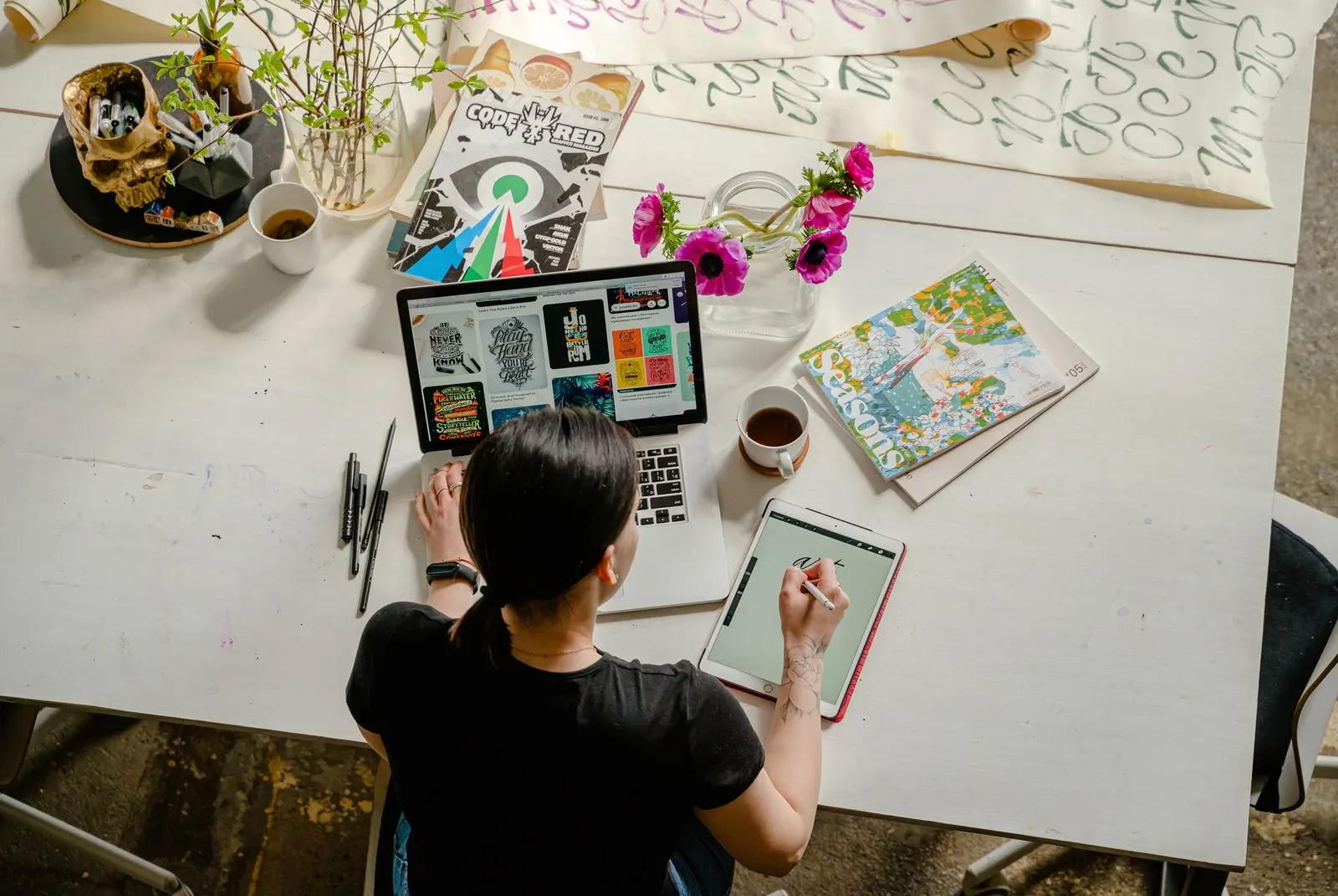 A designer working between sketches and a screen
