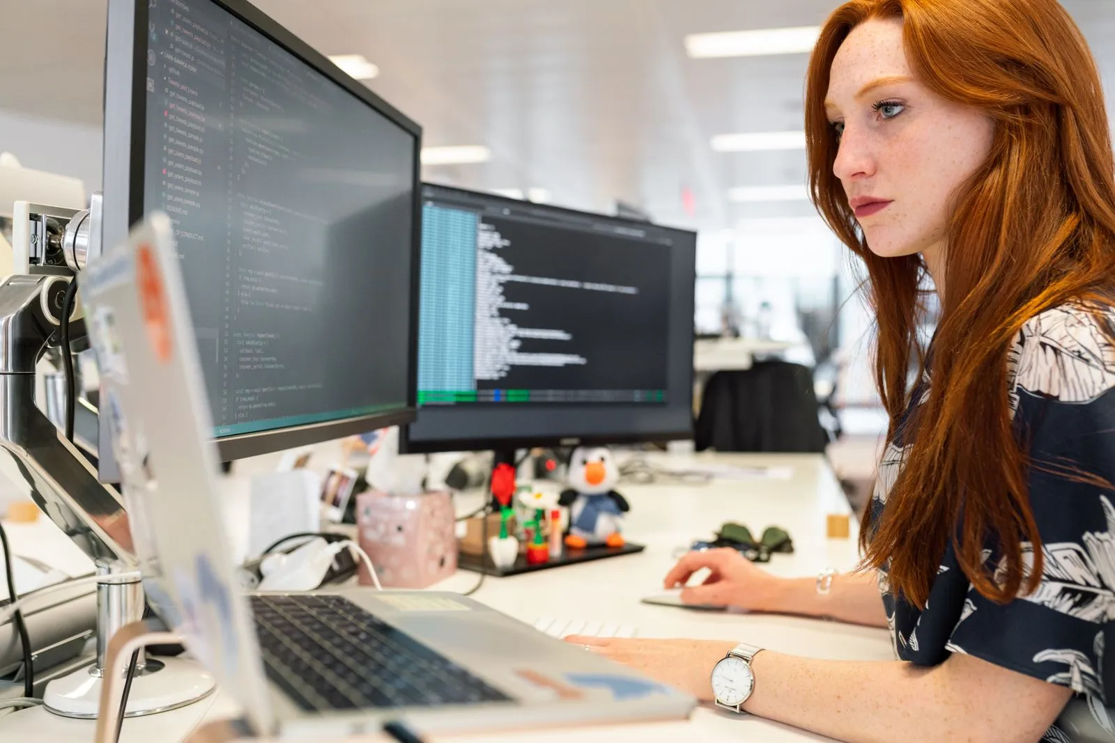 A developer working across several screens